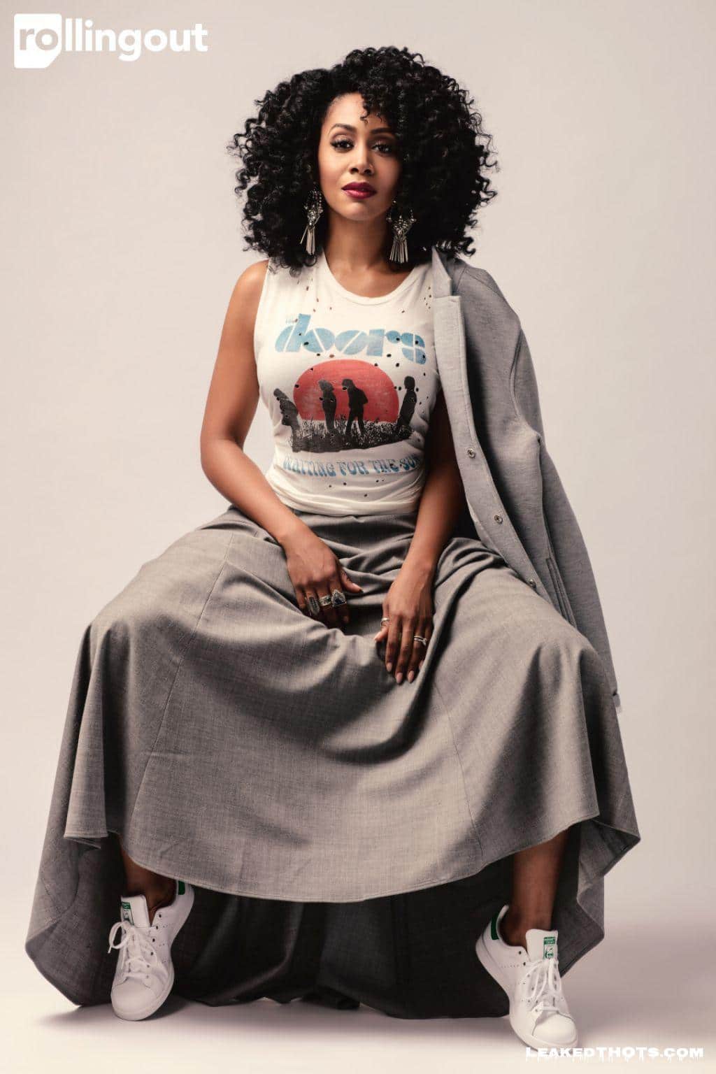 Simone Missick in a dress spreading her legs
